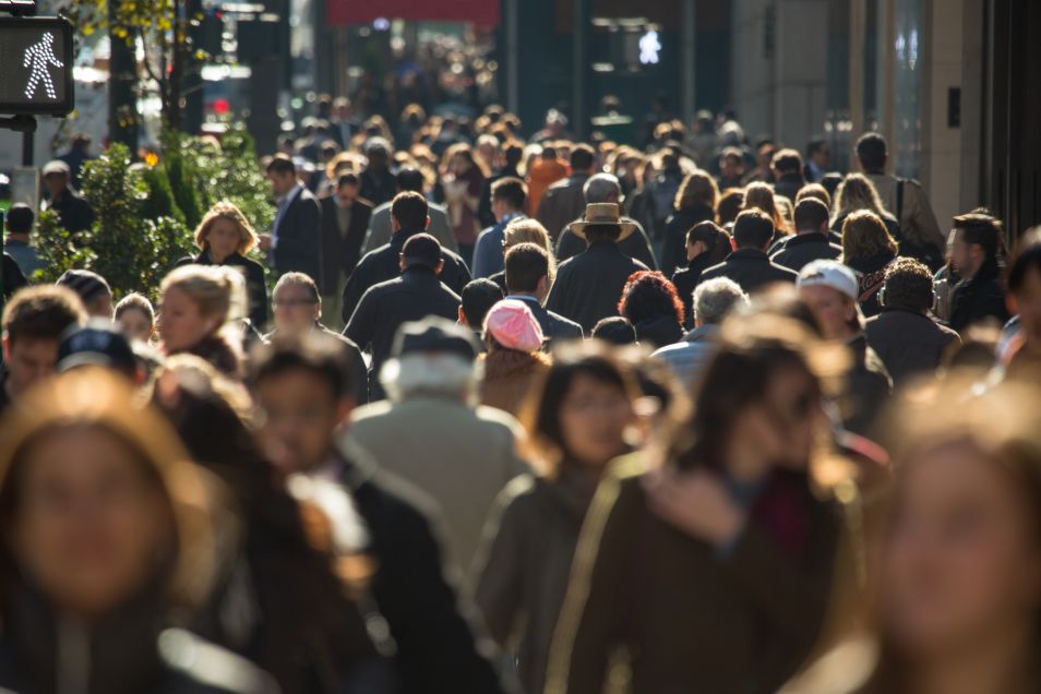Crowd of anonymous people walking on busy New York City street