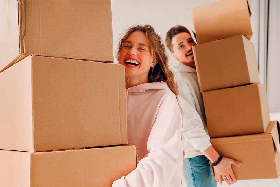 Where Are People Moving to in 2026. Couple with moving boxes.